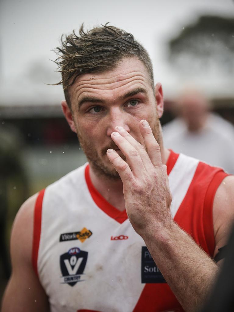 A sodden Sorrento coach Luke Tapscott addresses his players at a break in the MPNFL. Picture: Valeriu Campan