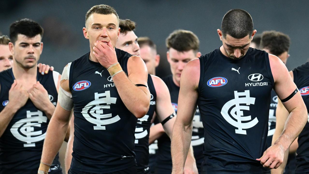 Patrick Cripps (left) leads his side off the field after another loss. Picture: Quinn Rooney