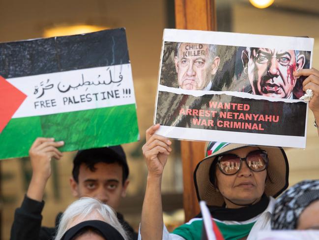 People hold placards as they take part in an interfaith protest in solidarity with Palestinian people outside the High Court in Cape Town. Picture: AFP