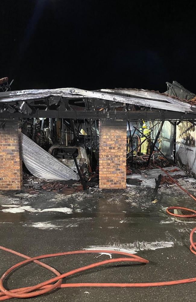 A burned out car in one of the gutted garages at the retirement village at Mt Warren Park.