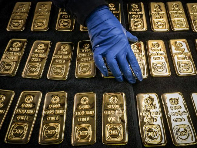 A worker handles ABC Bullion one kilogram gold bars at the ABC Refinery smelter in Sydney, New South Wales, Australia, on Thursday, July 2, 2020. Western investors piling into gold in the pandemic are more than making up for a collapse in demand for physical metal from traditional retail buyers in China and India, helping push prices to an eight-year high. Photographer: David Gray/Bloomberg