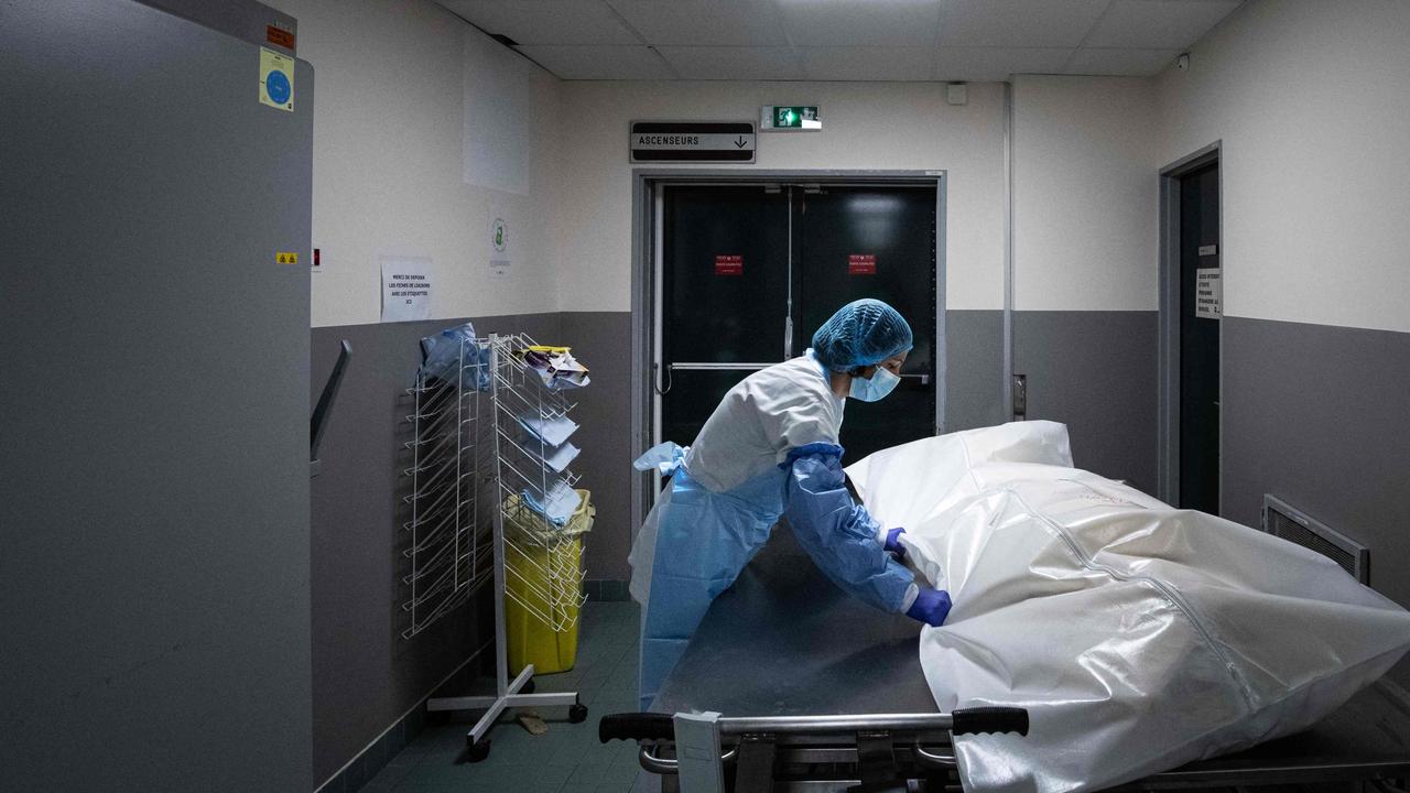 A hospital worker moves the body of a deceased COVID-19 patient in Paris, which is in the grips of a horror third wave of infections. Picture: AFP