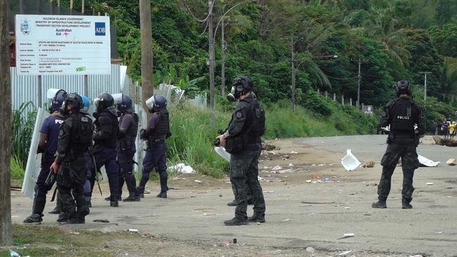 Australian Federal Police officers patrolling with local police in Honiara in 2021 after days of rioting. Picture: AFP