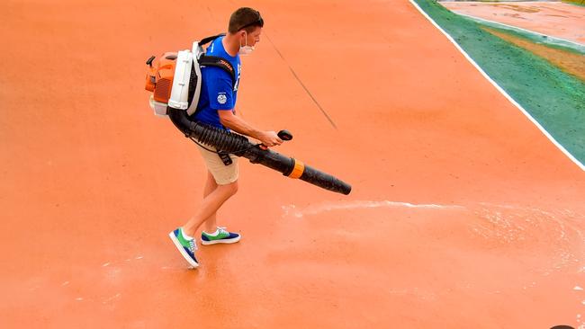 A volunteer uses an air blower to remove water from the Sam Willoughby International BMX Facility Picture: AusCycling