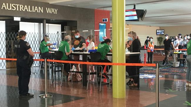 Passengers from Adelaide arrive at Alice Springs Airport on Monday.