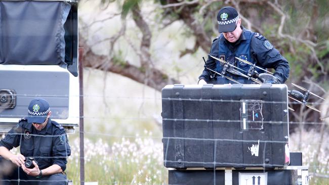 Police with a drone at the scene where a man was fatally shot. Picture: Dylan Coker