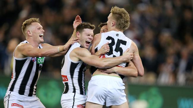 Collingwood players swamp Jaidyn Stephenson after he booted a preliminary final goal. Pic: Michael Klein