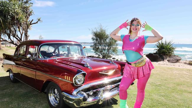 Australia’s largest nostalgia festival, Cooly Rocks On, which traditionally covered the music, lifestyle and cars from the 1950s, 60s and 70s, is this year unveiling a brand new precinct, covering all things 80s. Miss Roxanne La Roller bringing a different look to a classic Chevrolet at Coolangatta. Picture: Glenn Hampson.