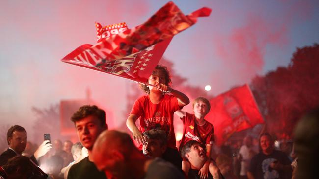 Liverpool fans celebrate as their team clinches the Premier League title at Anfield on June 25, their first championship in 30 years. Picture: Getty