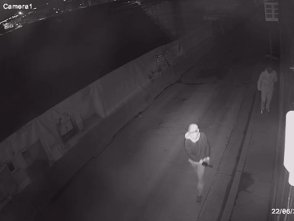 Two men – both depicted wearing face coverings and hooded jumpers, one of whom has a distinctive ‘CK’ on the back – were seen in the vicinity of Humphries Lane between 1am and 1.20am and last seen heading toward Prince Street a short time after the fire took hold. Picture: NSW Police