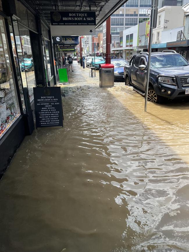 Water from the burst water main flooded Liverpool Street between Harrington and Murray Street. Picture: supplied.