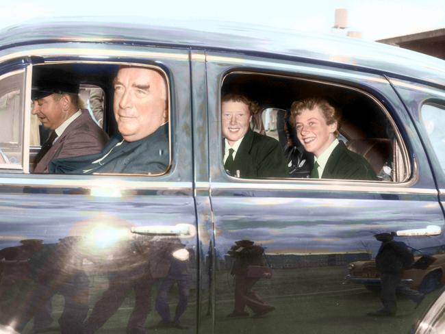 Prime Minister Robert Menzies gives athlete Betty Cuthbert and teammate Heather Innes a lift from the Olympic Village to the main stadium in 1956. Picture: HWT Library