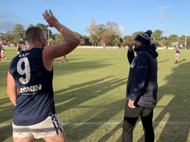 Edi-Asp coach Ben Walker celebrates with player Trent Robertson (No.9) moments after the siren.