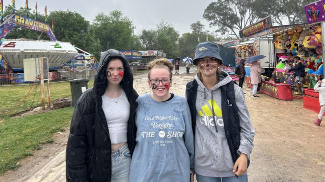 Bree Williams, Abbey Richards and Amanda Ward braved the rain on Friday at the Benalla Show.