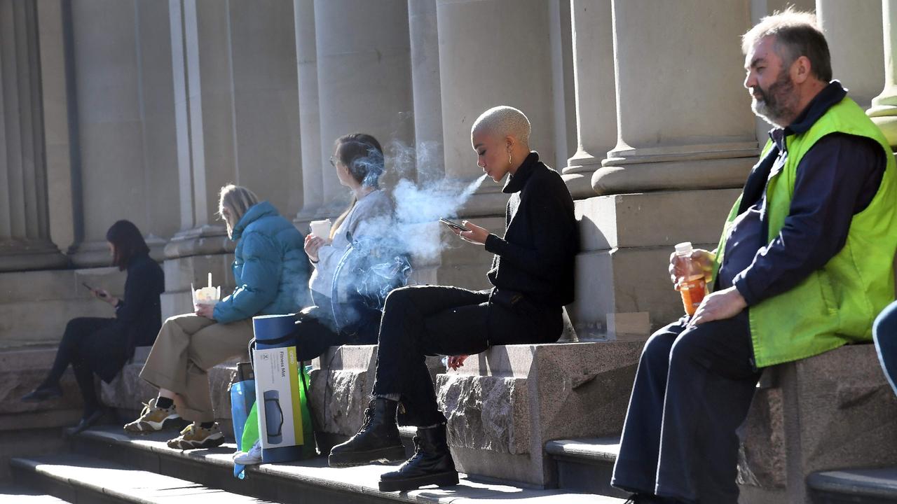 Workers take a break in the winter sun in Melbourne's central business district on June 17, 2020, as more Australians return to the city centre with a relaxing of the COVID-19 coronavirus rules. Picture: William West/AFP