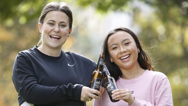 Fitness fanatics Mizz Barkes and Angela Nguyen take a break from exercise to try the zero alcohol Carlton Zero. Picture: David Caird