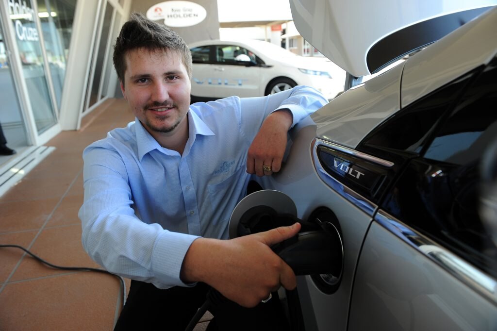 CHARGED UP: Ross Gray Holden's sales consultant Scott Rub charges up Holden's new extended-range electric vehicle, the Volt. Photo: Max Fleet / NewsMail. Picture: Max Fleet