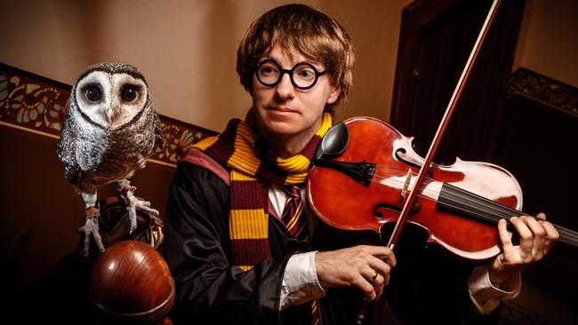 Adelaide Symphony Orchestra viola player Michael Robertson in costume as Harry Potter with Oscar the Sooty Owl in Minchin House at the Adelaide Zoo. Picture: Matt Turner.