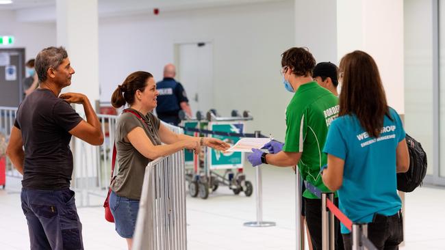 Vanessa Farmer greets one of her three sons who were evacuated from their Adelaide boarding school. Picture: Che Chorley