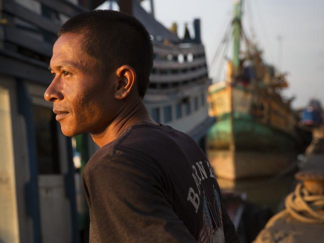 A fishing boat worker rests while his boat is at the port in Songkhla, Thailand. Picture: Paula Bronstein