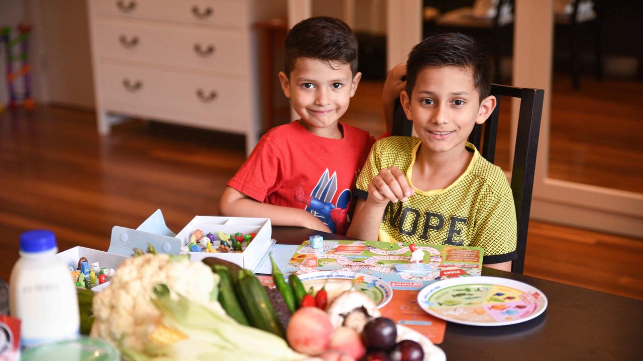 Brothers Sriyan, 5, and Ethan, 8, play and learn with Coles fruit and vegetable collectables Stikeez. Picture: Flavio Brancaleone