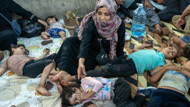 A woman watches over sleeping children as shelter outside after being displaced by Israeli air strikes on September 28, 2024 in Beirut, Lebanon. Picture: Carl Court/Getty Images