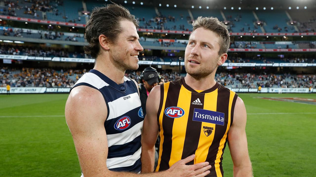 MELBOURNE, AUSTRALIA - APRIL 05: Isaac Smith of the Cats and Luke Breust of the Hawks embrace after the 2021 AFL Round 03 match between the Geelong Cats and the Hawthorn Hawks at the Melbourne Cricket Ground on April 05, 2021 in Melbourne, Australia. (Photo by Michael Willson/AFL Photos via Getty Images)