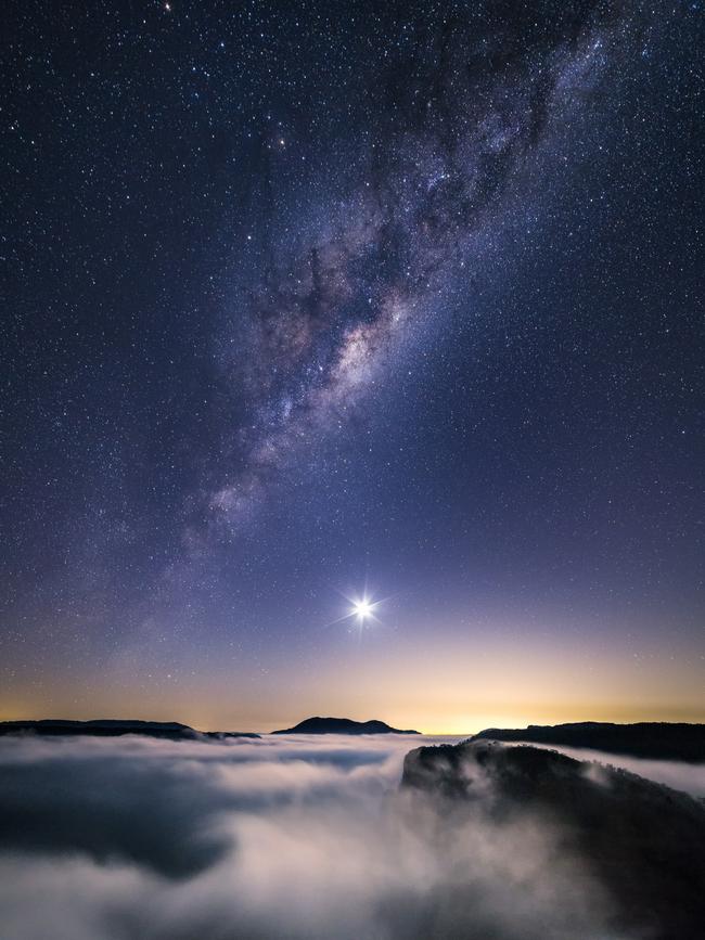 Insight Astronomy Photographer of the Year 2017 shortlist selection: Crescent Moon over Mount Banks . Picture: Luke Tscharke (Australia) In the Blue Mountains, the photographer jumped out of his sleeping bag, and left the campsite to see an early morning cloud inversion had swept across the Grose Valley, dancing as a soft warm breeze pushed it along its way. The galactic core of the Milky Way was visible above the waning crescent Moon, seemingly stacked over the silhouetted summit of Mount Banks. In the distance, beyond the city lights of Sydney, a brightening patch on the horizon indicated the rising Sun was soon to appear. The best things in life may be free but they do sometimes require an early alarm! Blue Mountains National Park, New South Wales, Australia, 6 March 2016