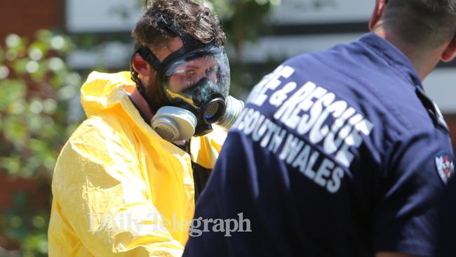 NSW Fire and Rescue officer wearing protective clothing about to enter the house. Picture: Tim Hunter