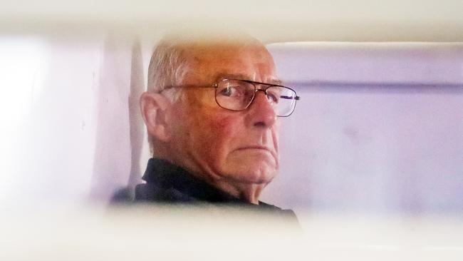 Roger Rogerson inside a police truck being taken into Bankstown Court in 2014 to face charges relating to the murder of Jamie Gao. Picture: Craig Greenhill