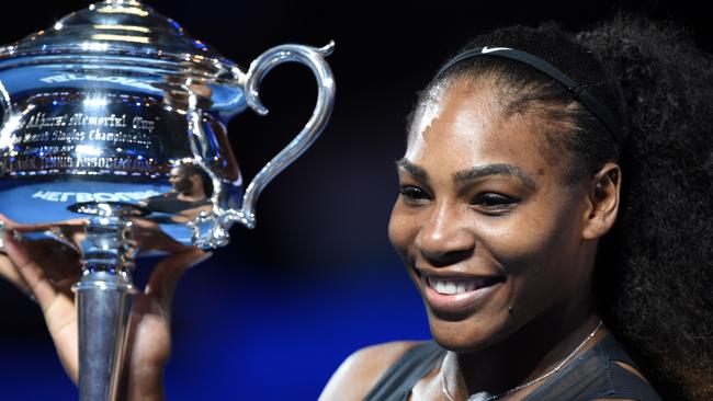 (FILES) This file photo taken on January 28, 2017 shows Serena Williams of the US holding up the winner's trophy following her victory over Venus Williams of the US in the women's singles final at the Australian Open tennis tournament in Melbourne. Defending champion Serena Williams pulled out of the Australian Open on January 5, 2018, saying she was "super close" but still not at the level she needs to be after giving birth to her first child. / AFP PHOTO / PAUL CROCK / IMAGE RESTRICTED TO EDITORIAL USE - STRICTLY NO COMMERCIAL USE