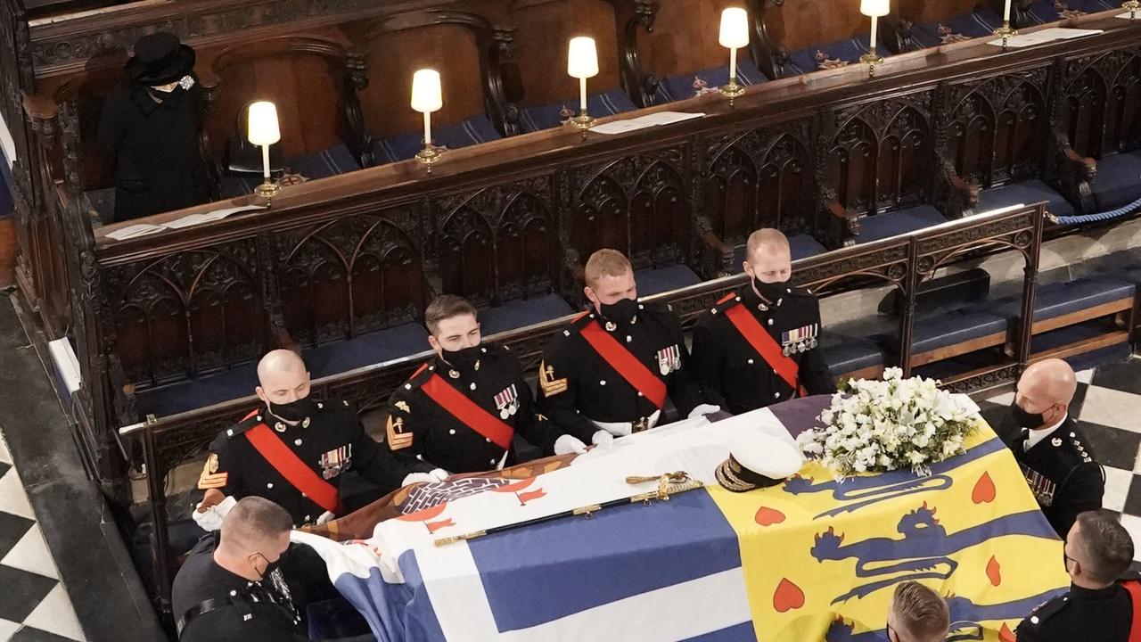 Queen Elizabeth II watching on as the pall bearers lift her husband’s coffin during his funeral service. Picture: Jonathan Brady – WPA Pool/Getty Images