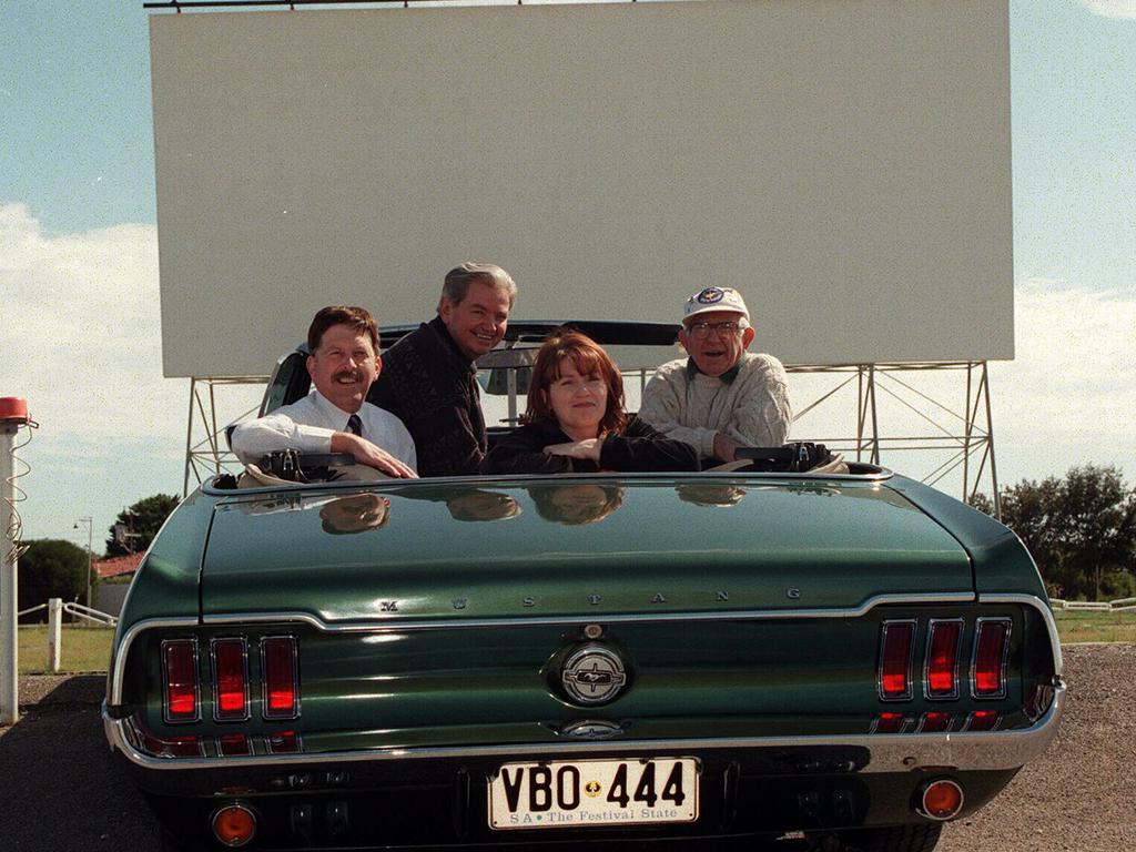 Wallis Theatre executives Bill Stone (left) and Bob Parr with SA filmmaker Lindy Taylor and car enthusiast Jeff Grandsen in 1968 Mustang convertible motor car at West Beach Blue-Line drive-in theatre.