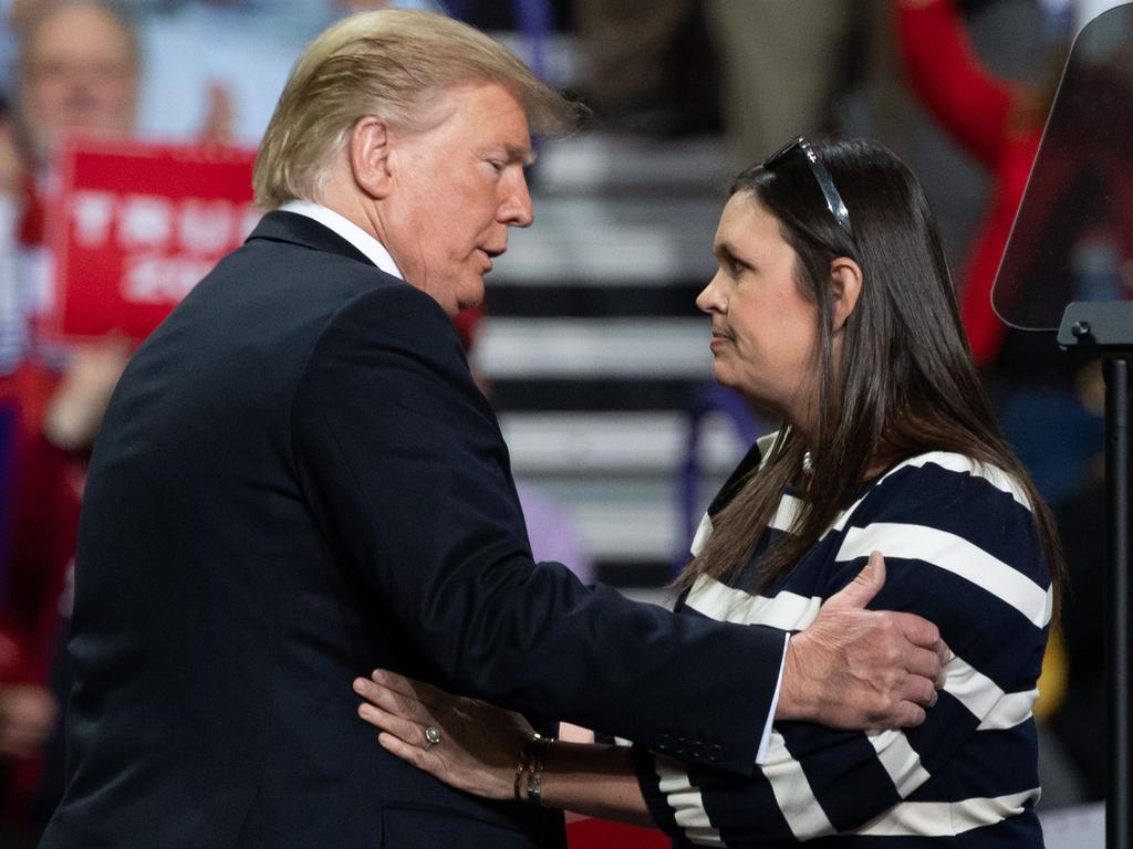 US President Donald Trump (L) embraces White House Press Secretary Sarah Huckabee Sanders during a Make America Great Again rally in Green Bay, Wisconsin. Picture: AFP