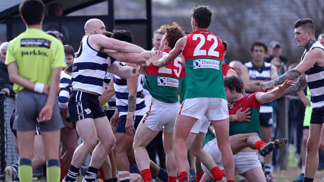 Chelsea and Pines players mix it up near the boundary line on Saturday. Picture: Mark Dadswell