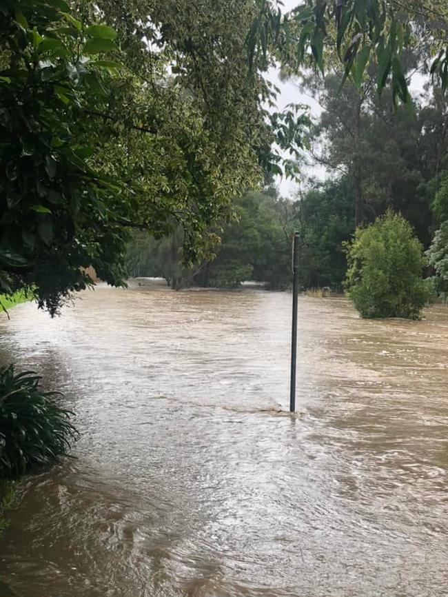 A footpath was engulfed by a flash flood after the Mittagong Creek spilled over on March 2. Picture: Maddie Midson