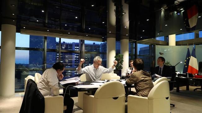 French Economy Minister Bruno Le Maire gestures as he and his advisers negotiate with European partners on the phone before the Eurogroup meeting at the minister's office in Paris. Picture: AFP