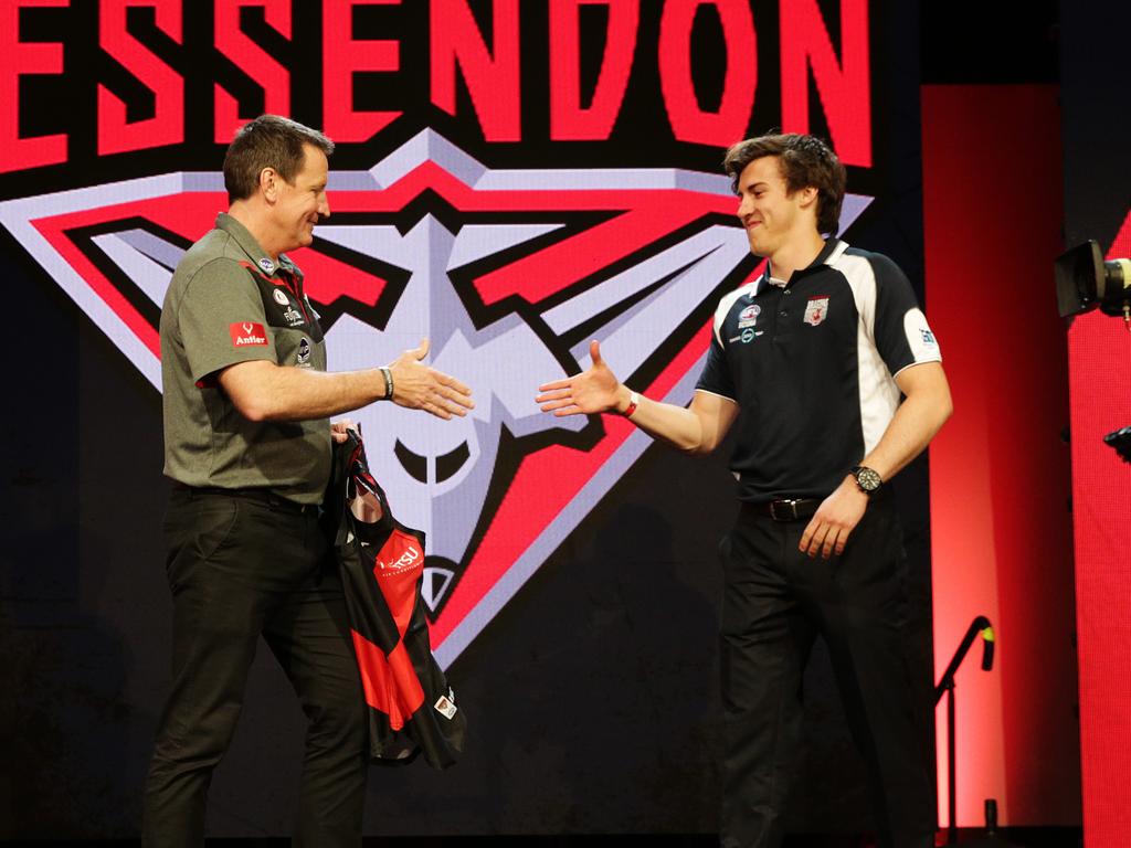 Then Essendon coach John Worsfold shakes hands with No. 1 pick Andrew McGrath. Picture: Toby Zerna