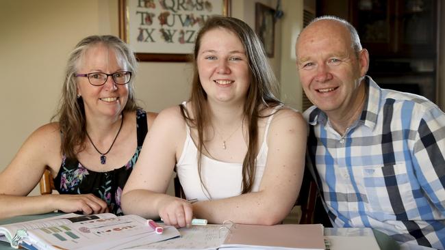 Cassie Cromie battled chronic costochondritis (chest pain) and missed the first half of Year 12, but still achieved outstanding grades. At home with her parents Sally-Jane and Andrew. Picture: Dean Martin