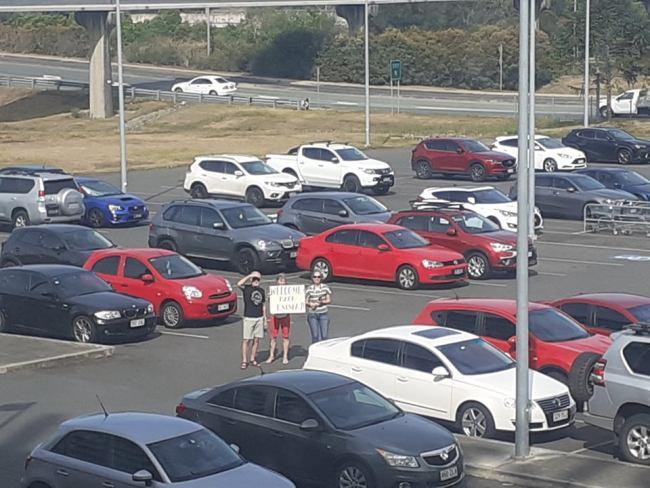 Emma Woods' parents in the car park of the hotel in Brisbane where she is in quarantine