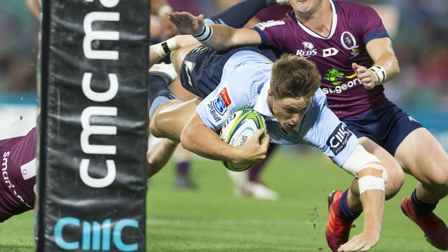 Alex Newsome crashes over for the Tahs. Picture: AAP