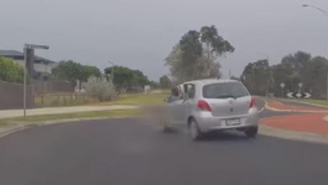 The dog was leaning out the window as the car went around the roundabout. Vision: Dash Cam Owners Australia