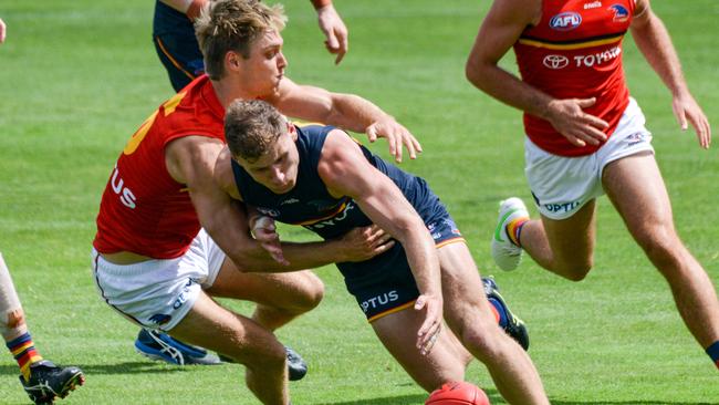 Jackson Hately wraps up Rory Laird during a Crows trial game.