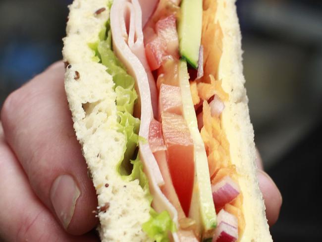 Leaf & Loaf owner Sacha Meikle with his  ham and salad sandwich, at his store in Orchid Plaza.