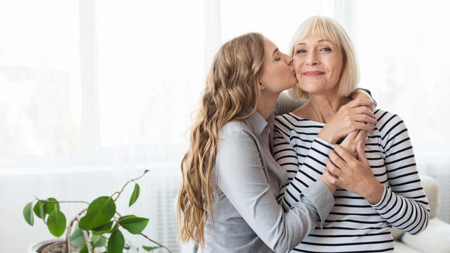 Young daughter kissing senior mother on the cheek. Picture: iStock