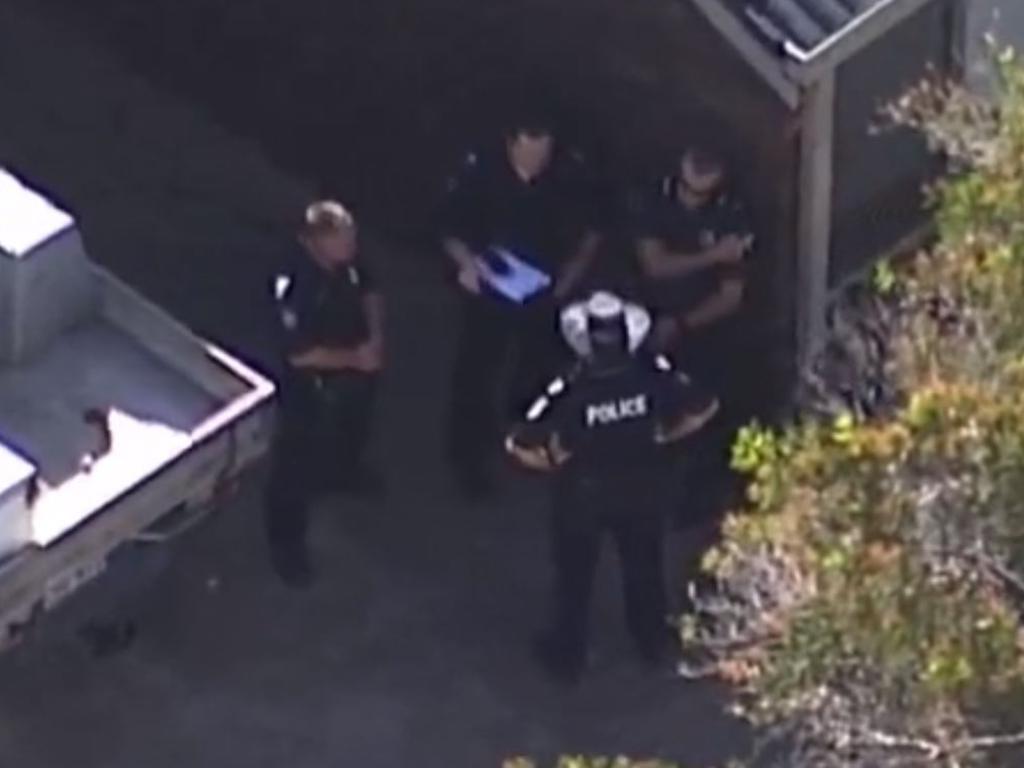 Police congregate outside the residence in Wynnum where a man's body was found on wednesday. He was aged in his 40s. Picture: Channel Seven