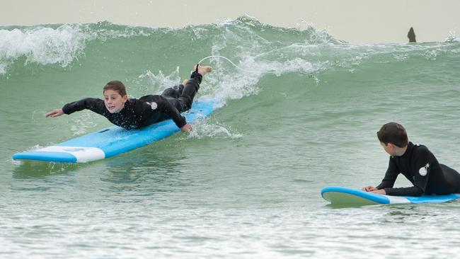 Enzo, 10, paddles into the break. Picture: Jay Town