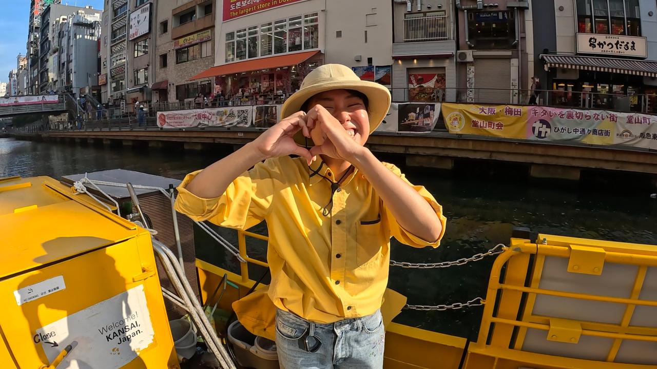 A Tombori River Cruise guide makes a heart with her hands as guests leave the boat. Picture: Chantelle Francis