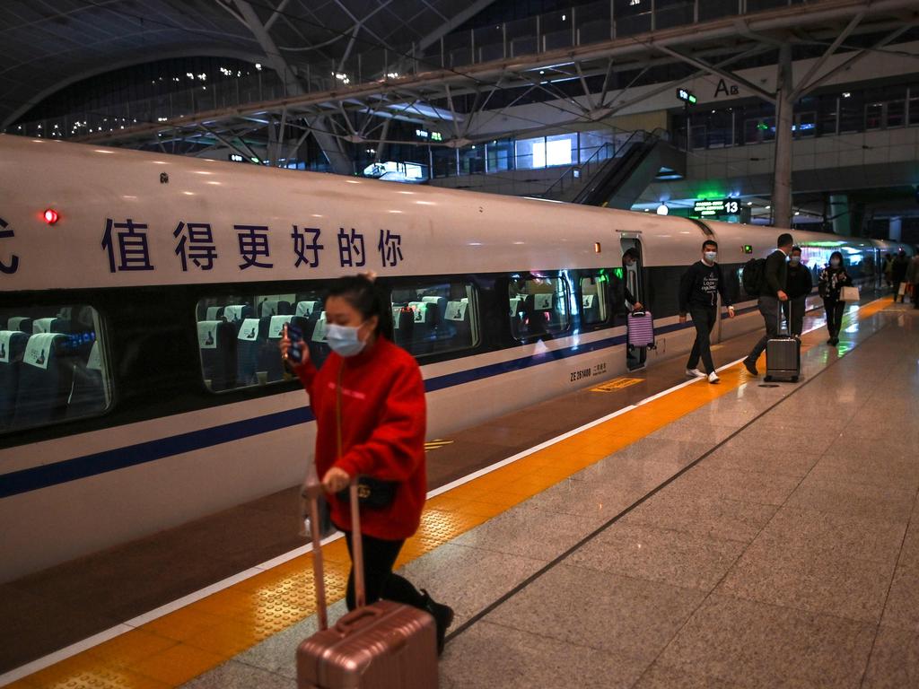 Passengers wearing face masks at the railway station in Wuhan, where the virus that has killed 1.3 million began. Picture: AFP