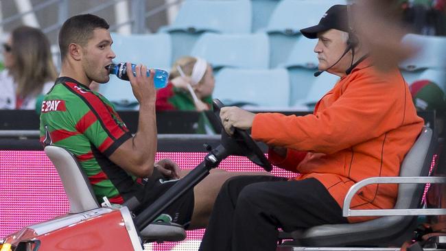 Braidon Burns of the Rabbitohs is taken from the field after injuring his leg. Picture: AAP Image/Craig Golding